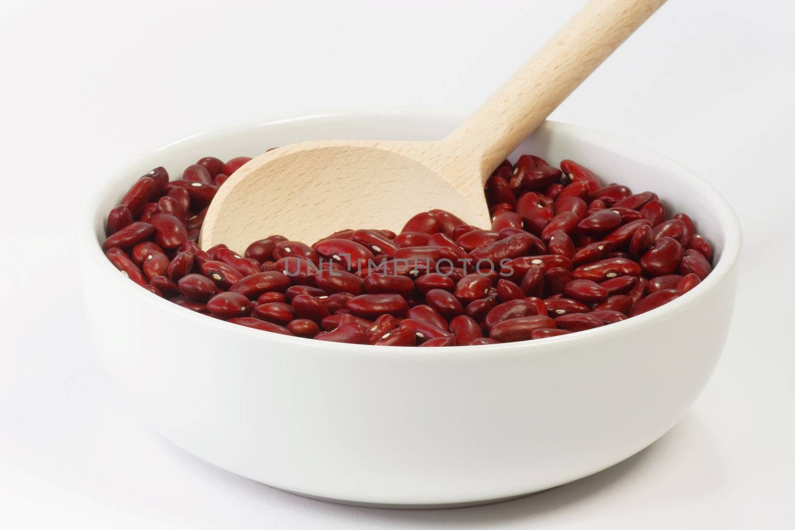 Red Kidney Beans in a white bowl on bright Background