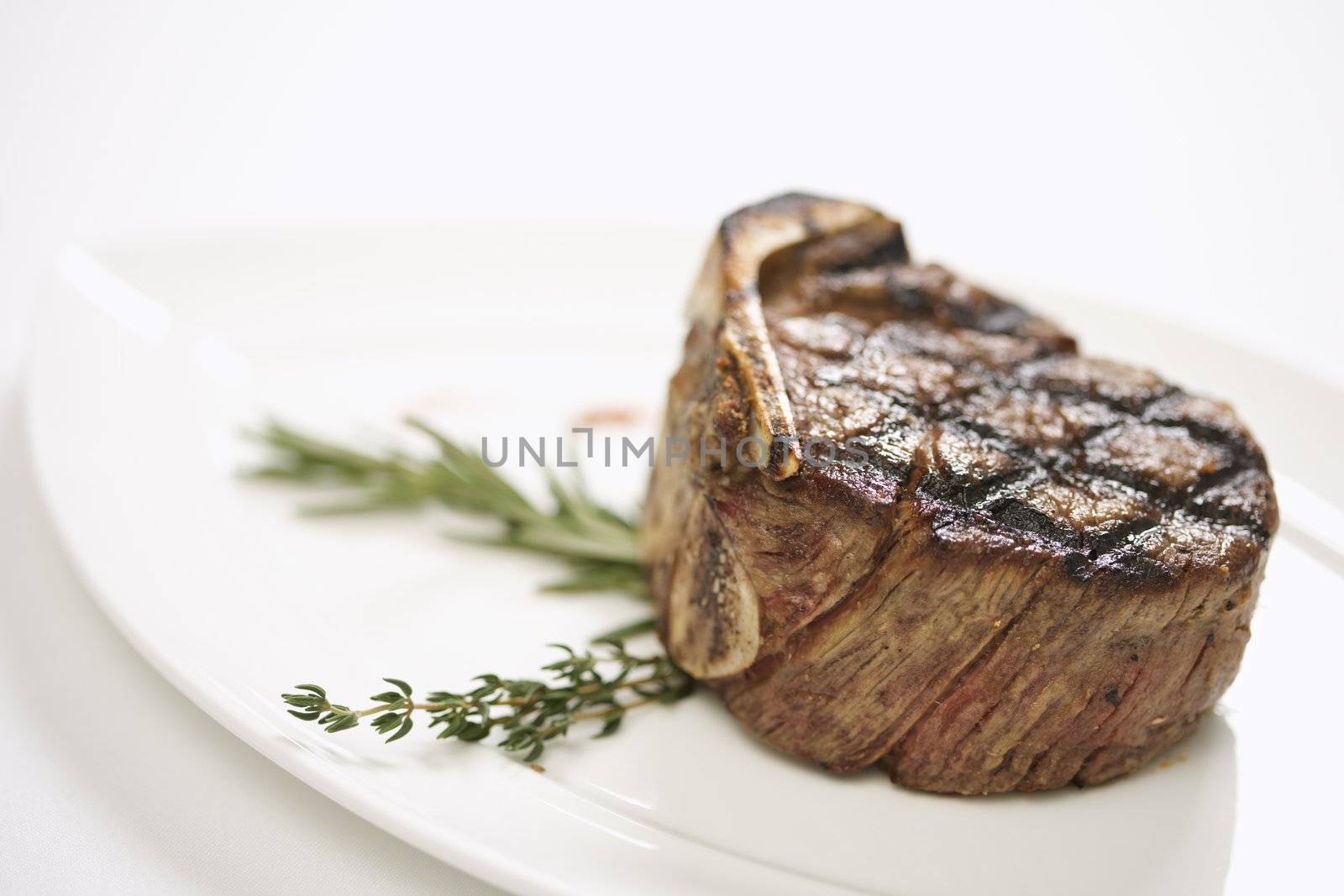 Grilled beef tenderloin on plate.