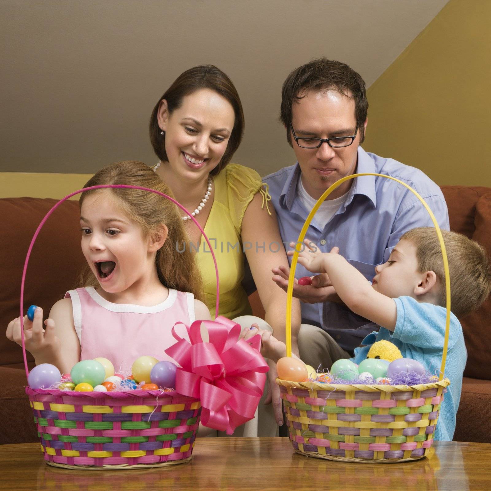 Caucasian family with looking at Easter baskets.