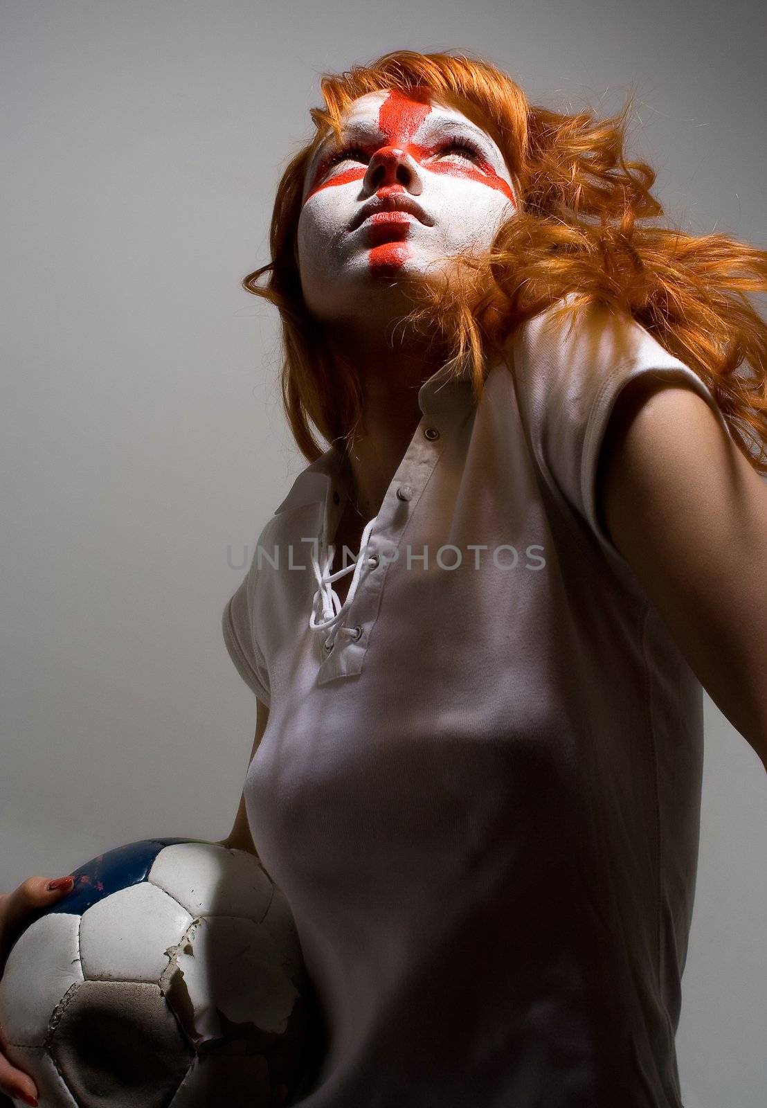 english football makeup girl holding worn soccer ball