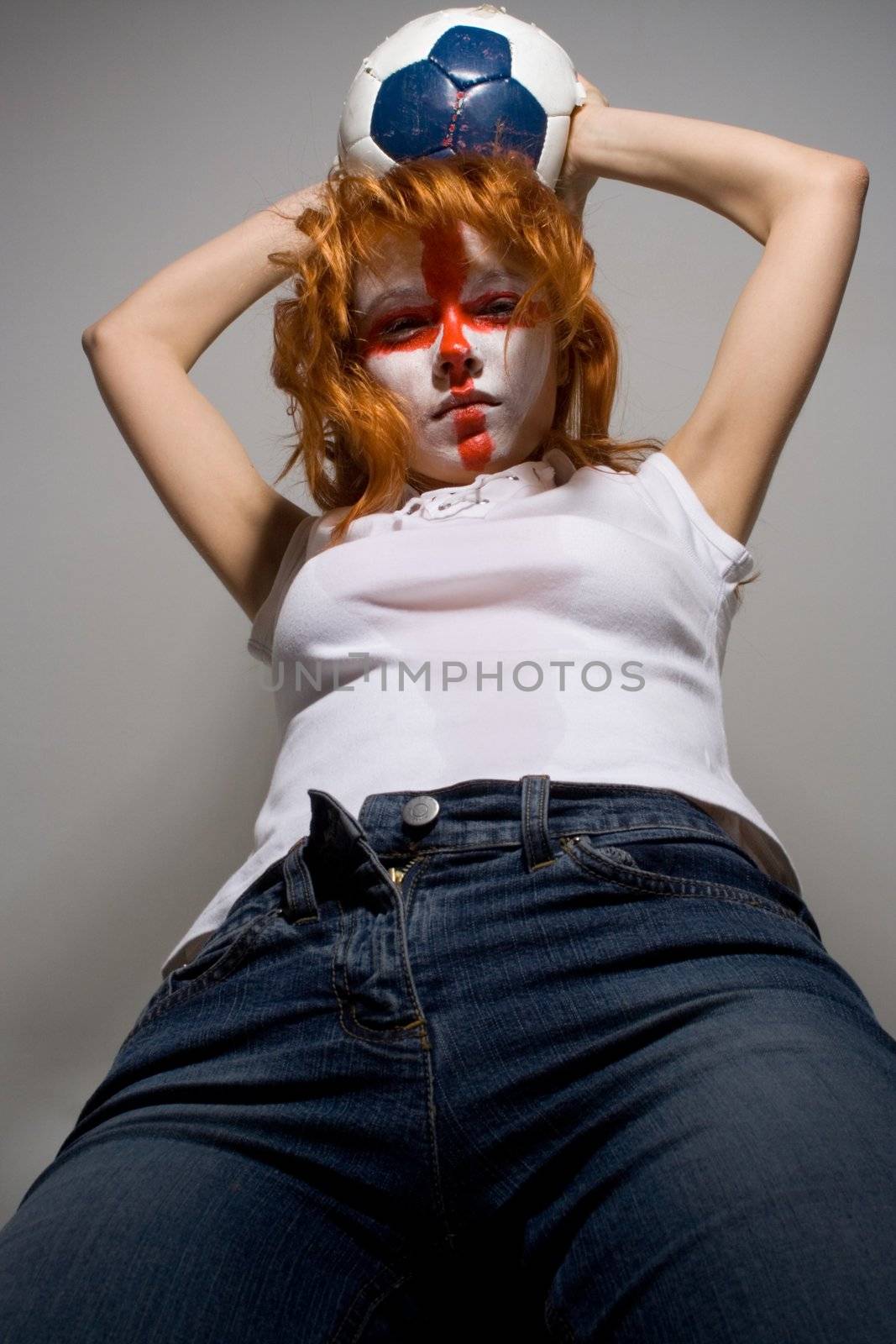 english football makeup girl holding worn soccer ball, ready to attack