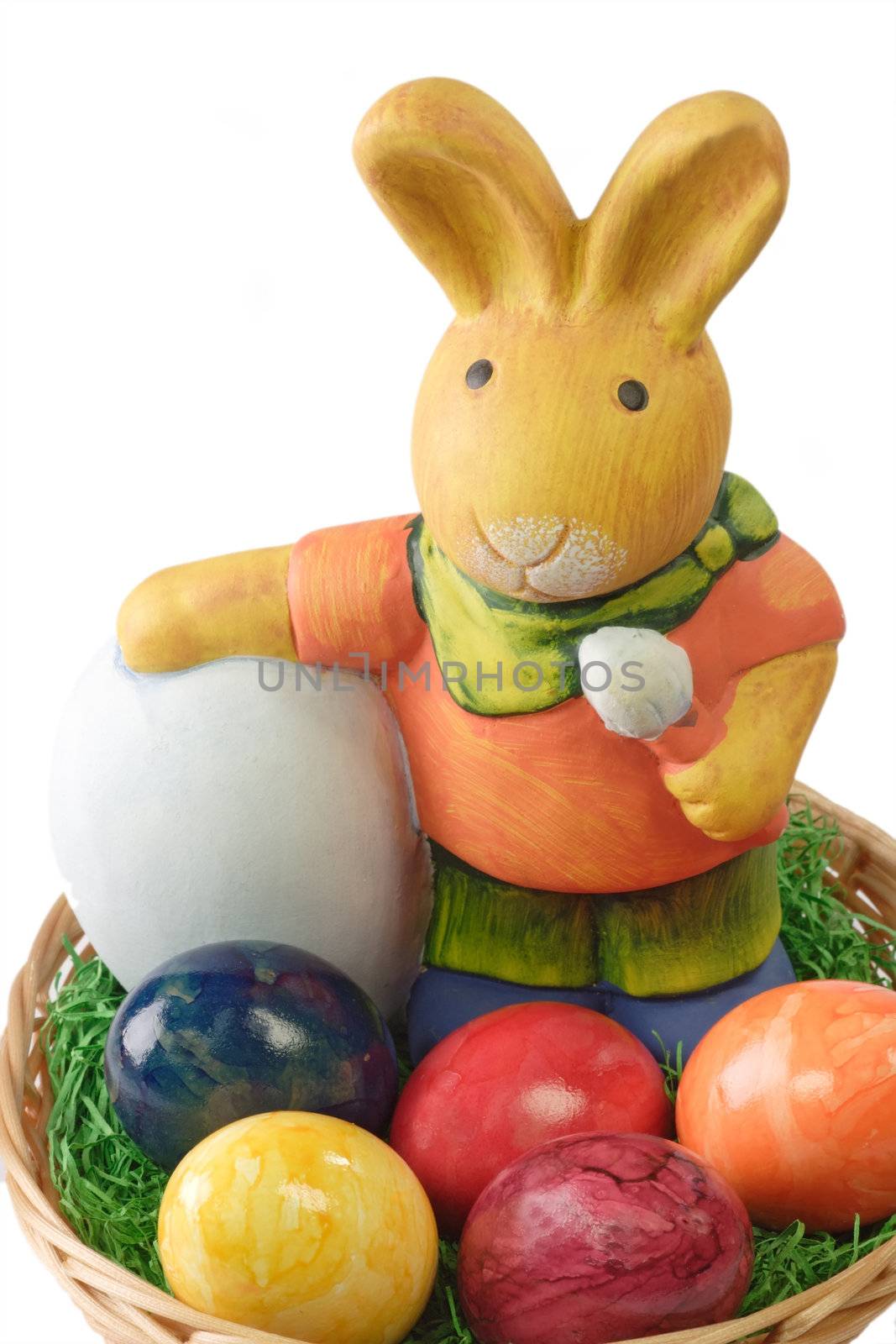 Close up of a basket with multicolored easter eggs and a bunny