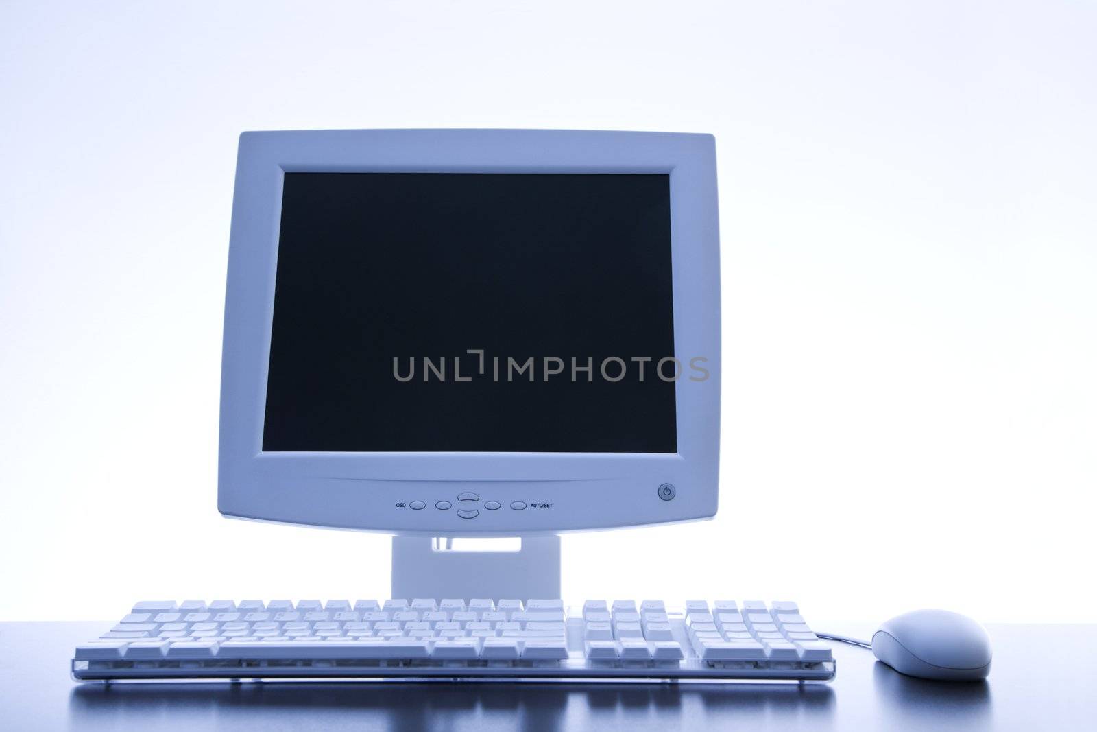 Still life of computer monitor, keyboard and mouse.