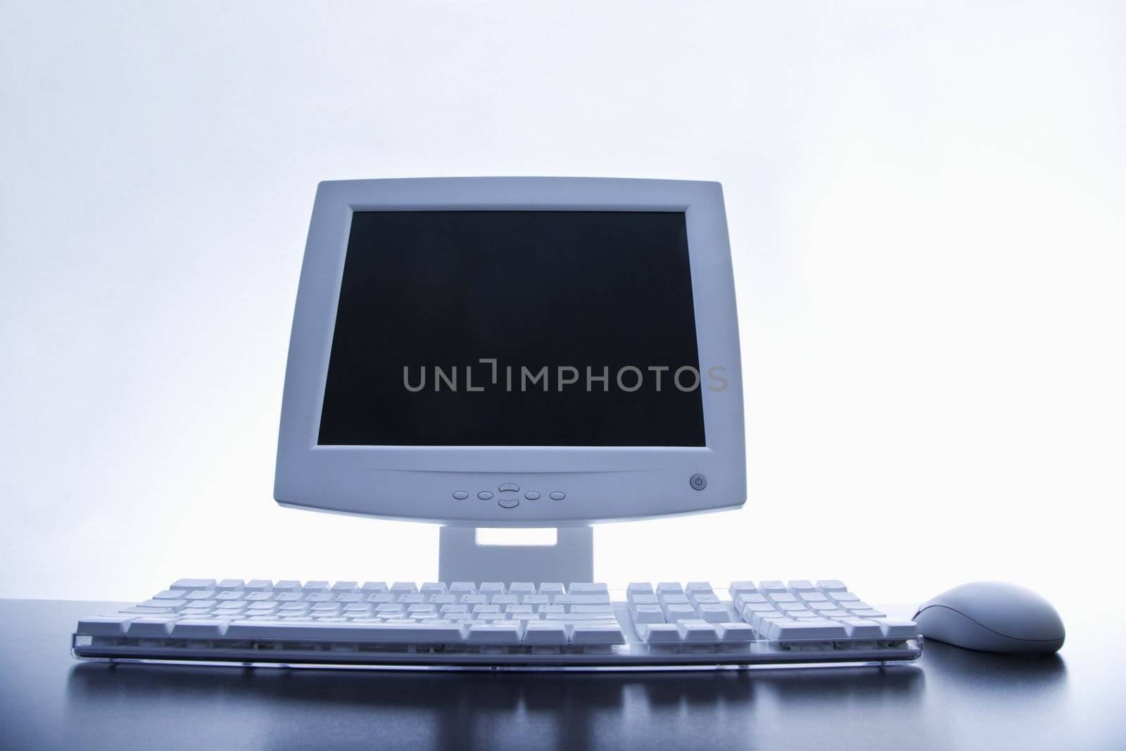 Still life of computer monitor, keyboard and mouse.