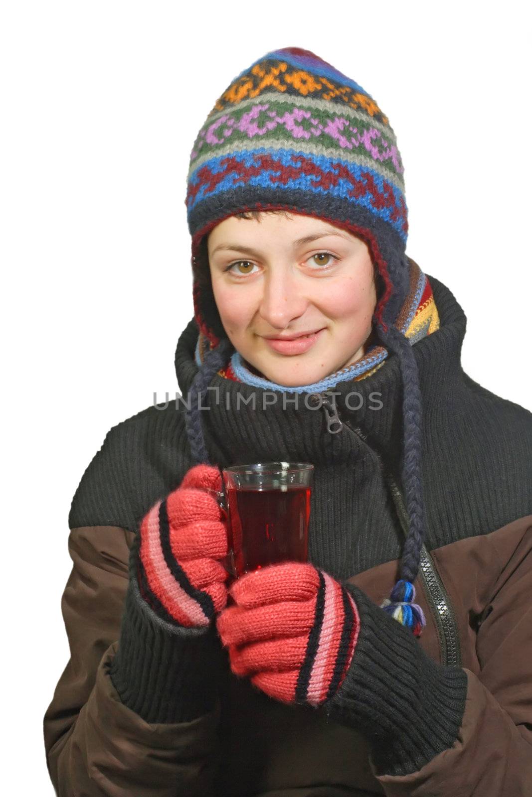 Young woman in winter dress holding a glass of tea