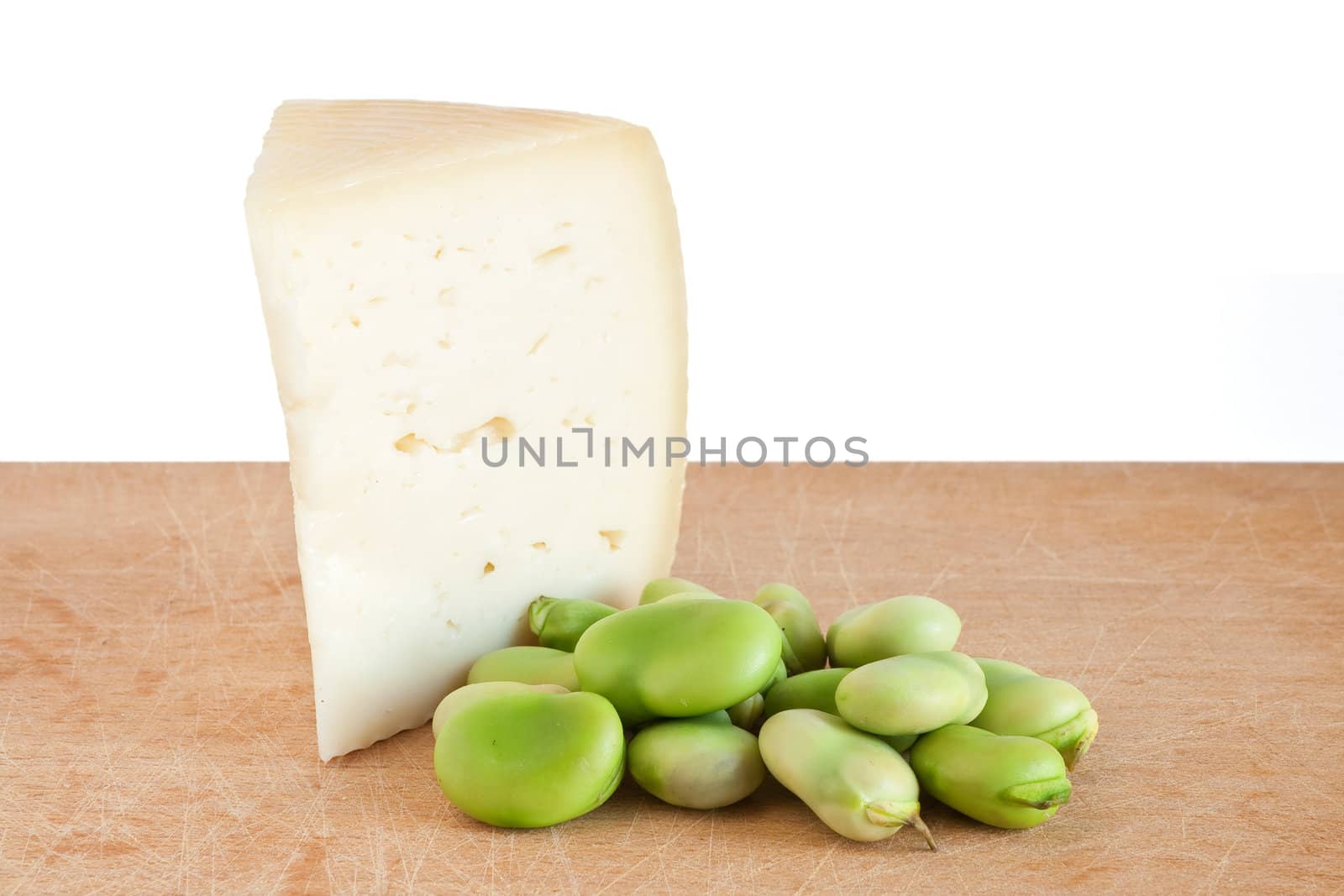 cutting board with pecorino cheese and broad beans isolated on white background with clipping path