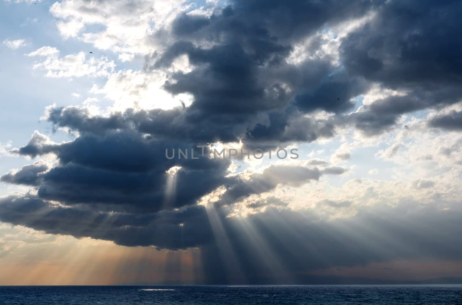 rays of sun through the clouds over the sea