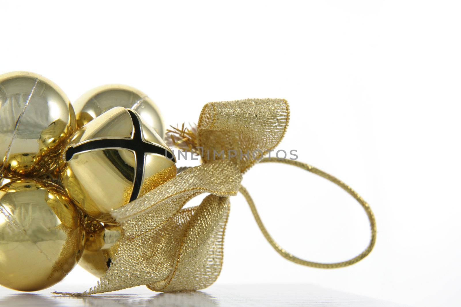 A golden bells Christmas ornament isolated on white.
