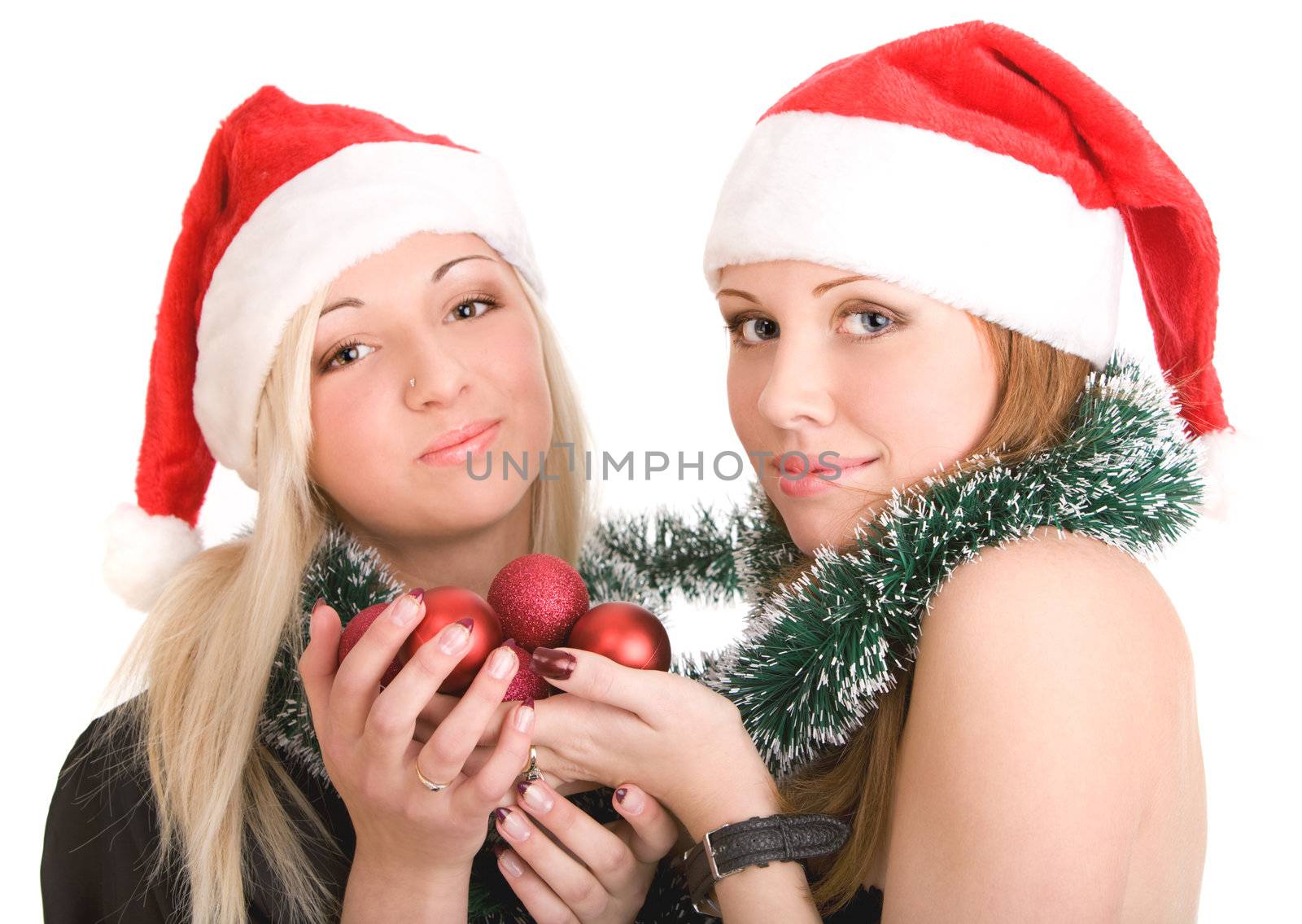 Two girls in Santa hats on isolated white