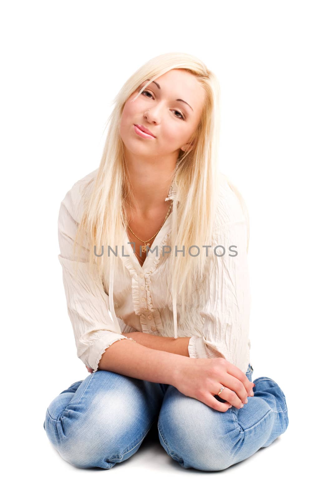 Cute young blond girl sitting on the floor
