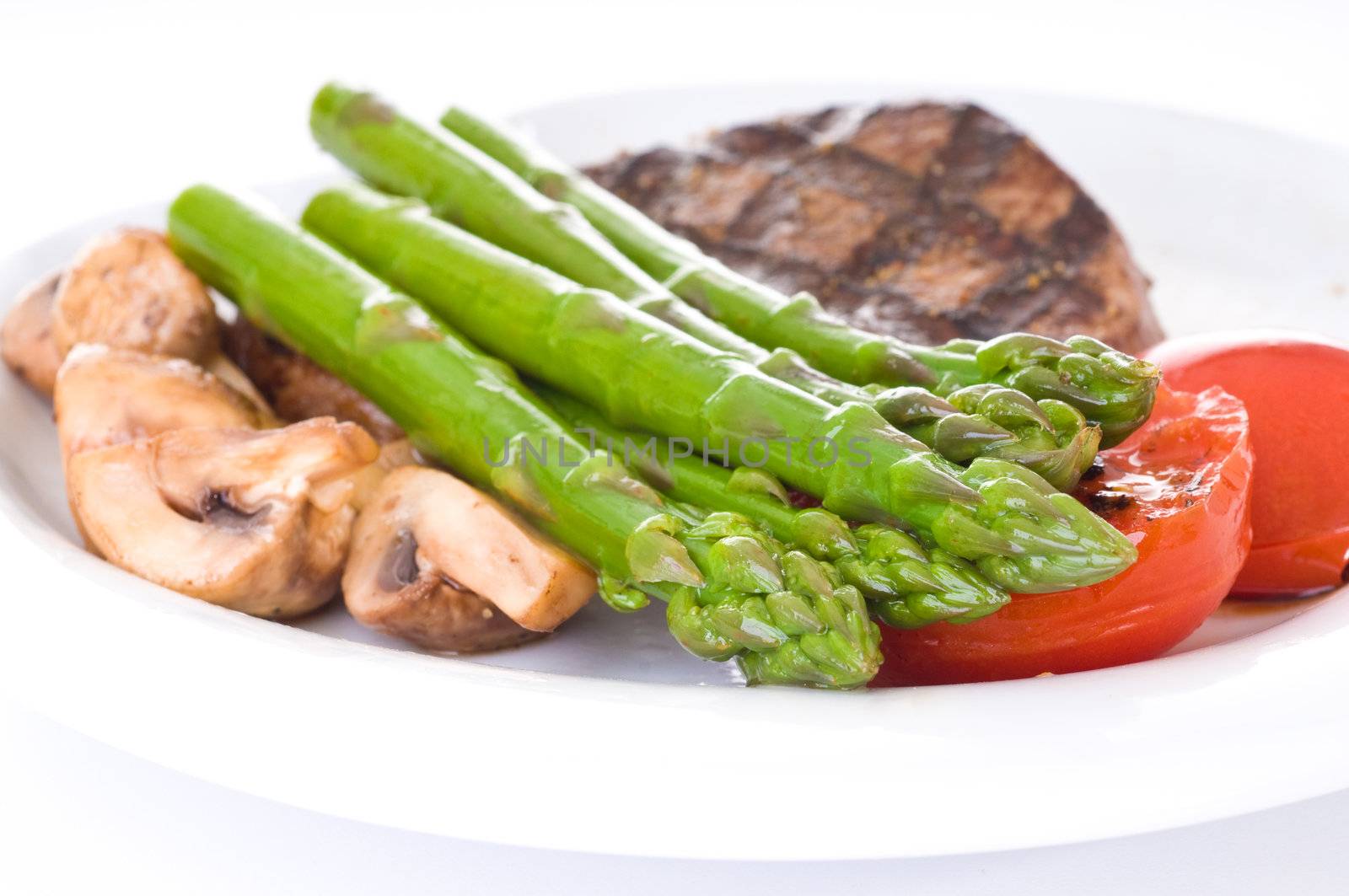 Fresh cooked asparagus accompanies a delicious meal.