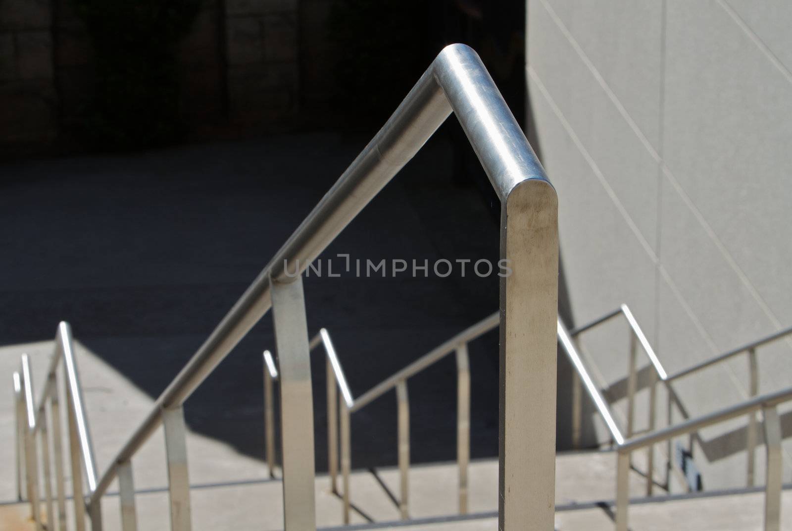 Close up of a shiny stainless steel railing  on stairwell