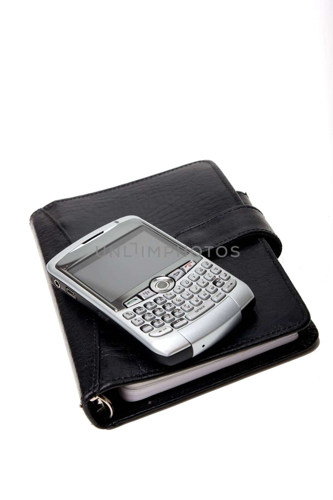 Closed Black Planner, with a silver PDA on top. On white.