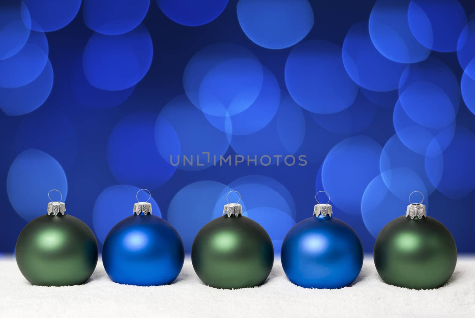 Christmas balls on the snow.  Background - blue christmas lights. aRGB.