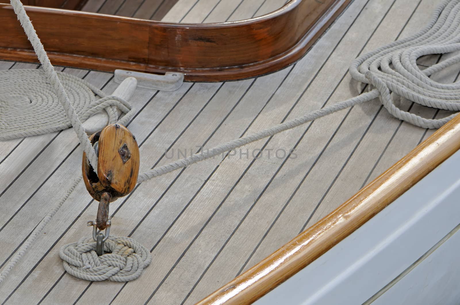 Detail of an old-fashioned wooden boat with block and rope