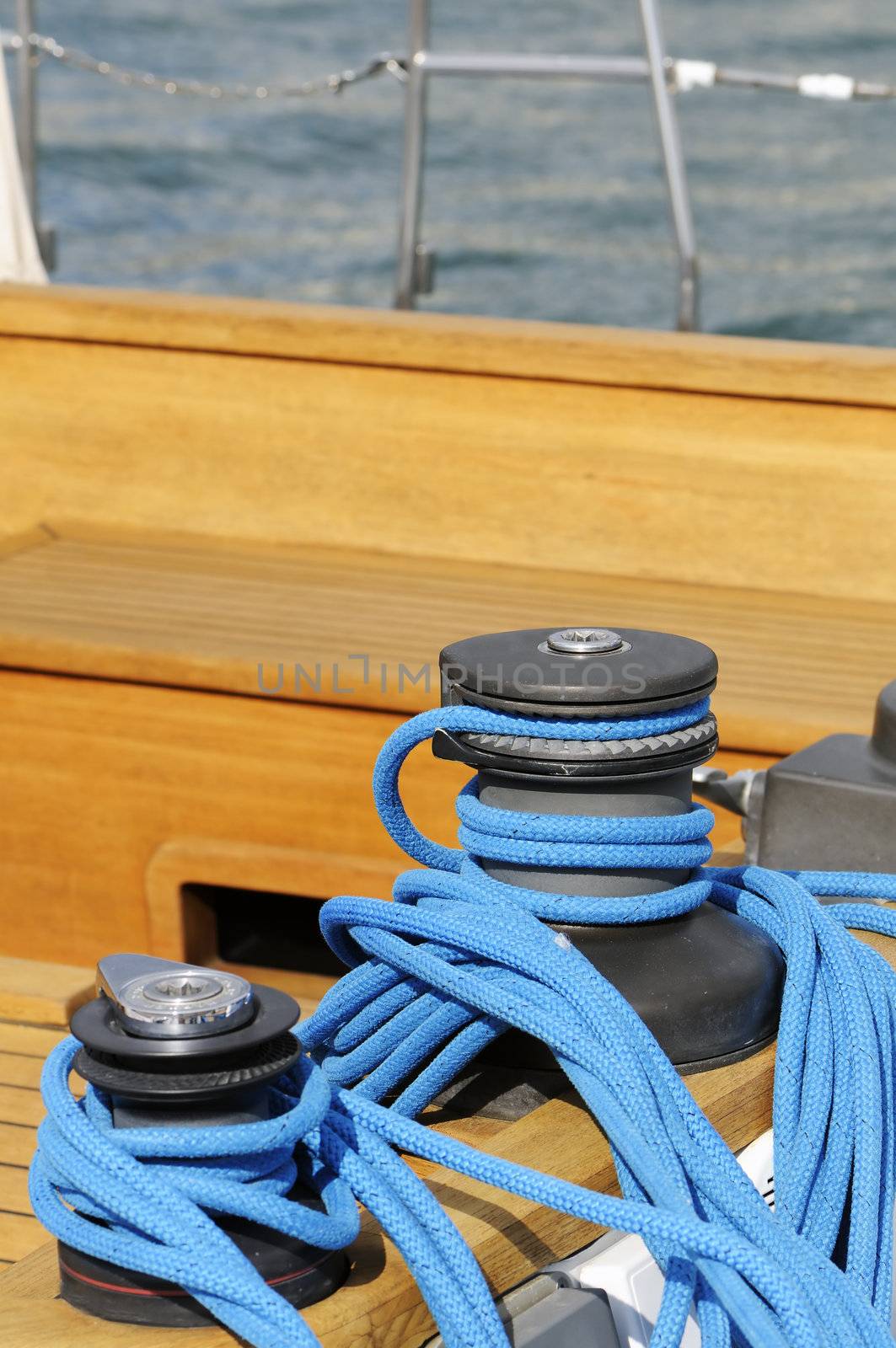 Wooden sailboat detail: two winches with a blue rope