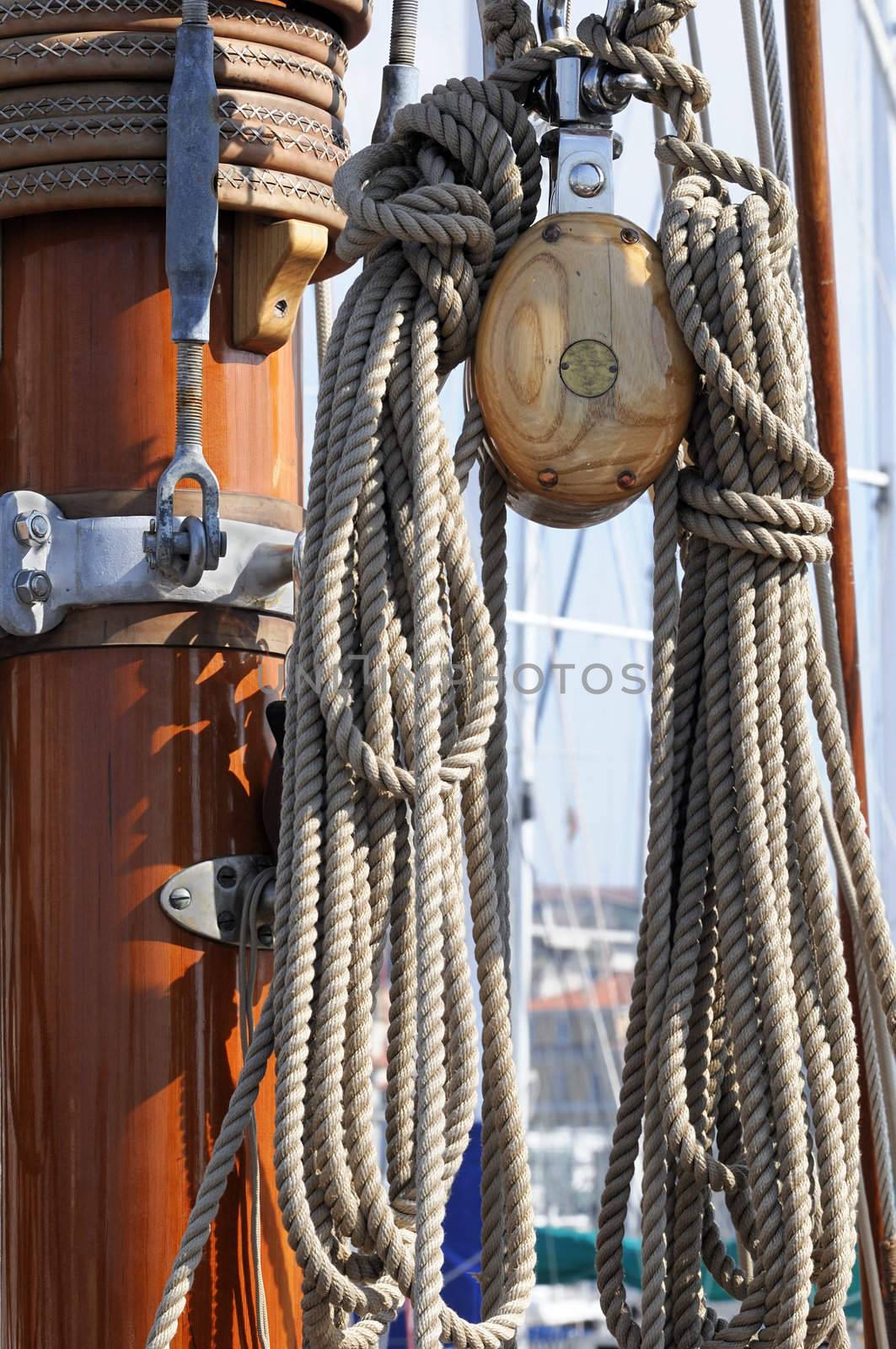 Detail of a wooden mast and block with ropes