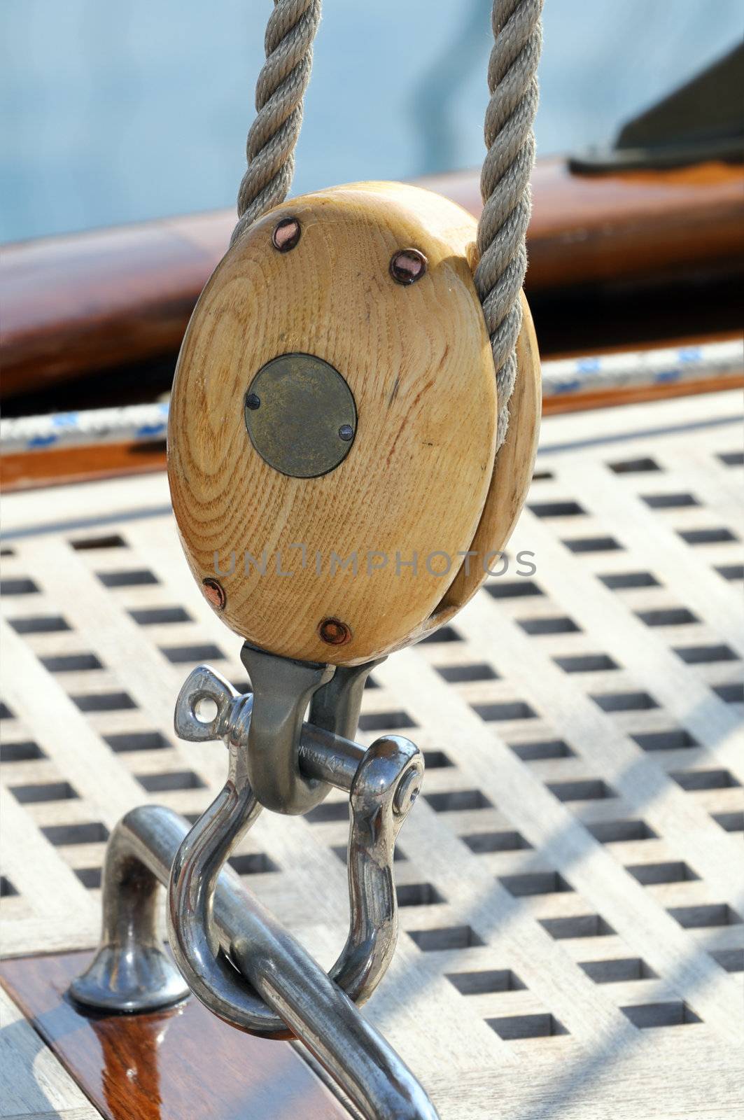 Close-up of a wooden pulley on a sailboat