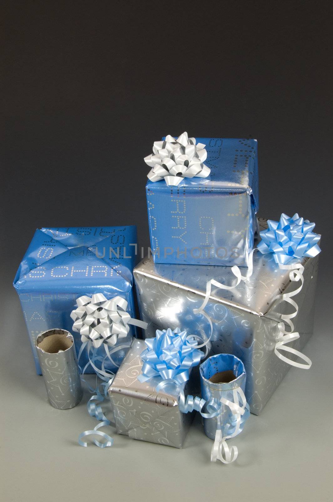 stock of blue and silver wrapped christmas presents with ribbons