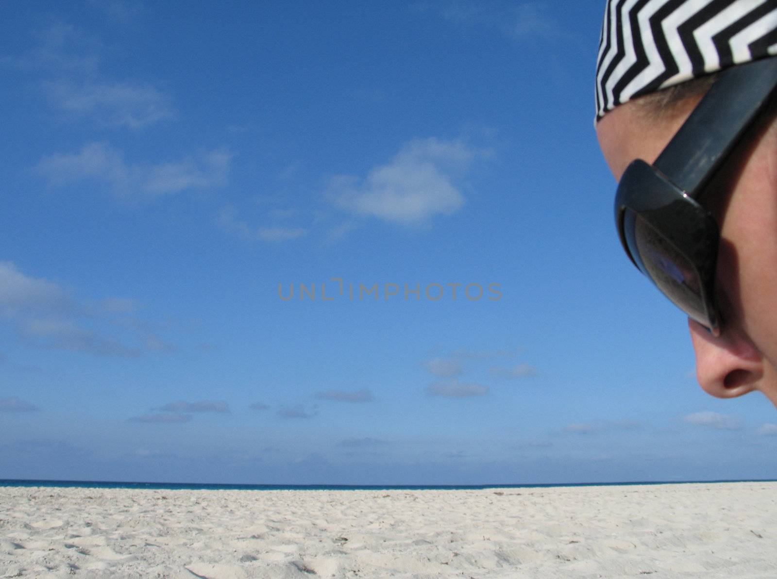 girl with shades on a beach by mmm