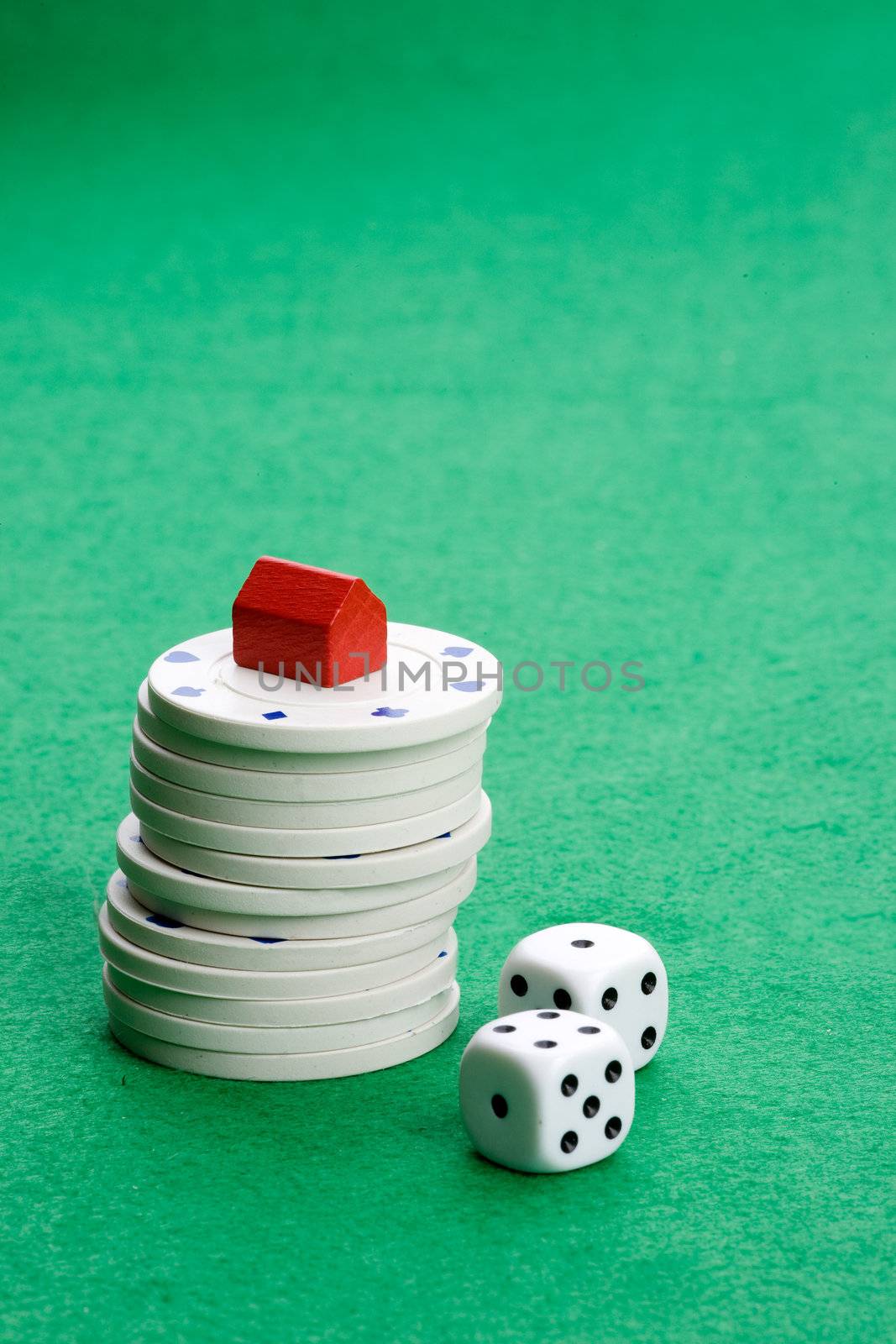 Casino chips with toy house - housing market gamble concept