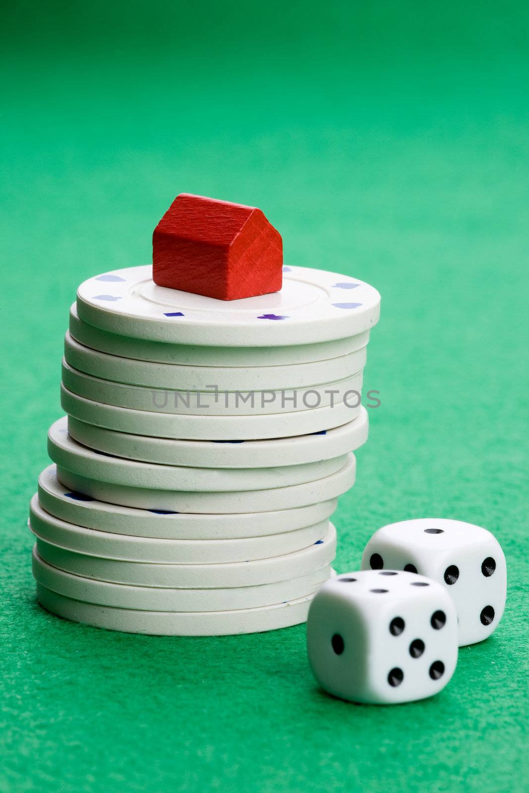 Casino chips with toy house - housing market gamble concept