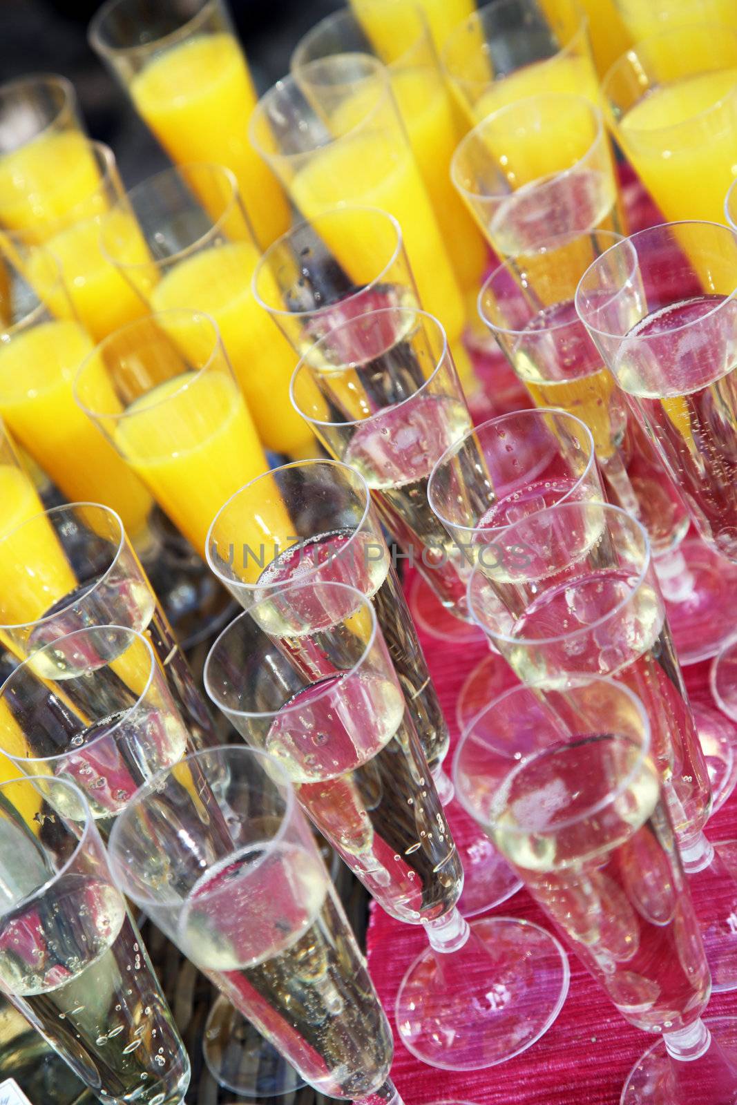 Many glasses of champagne and orange juice in a champagne reception