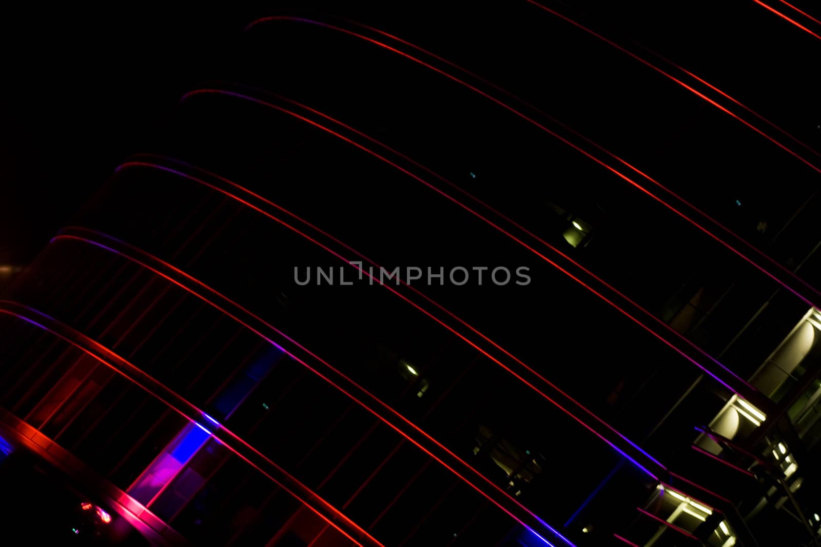 Illuminated skyscraper facade at night in downtown