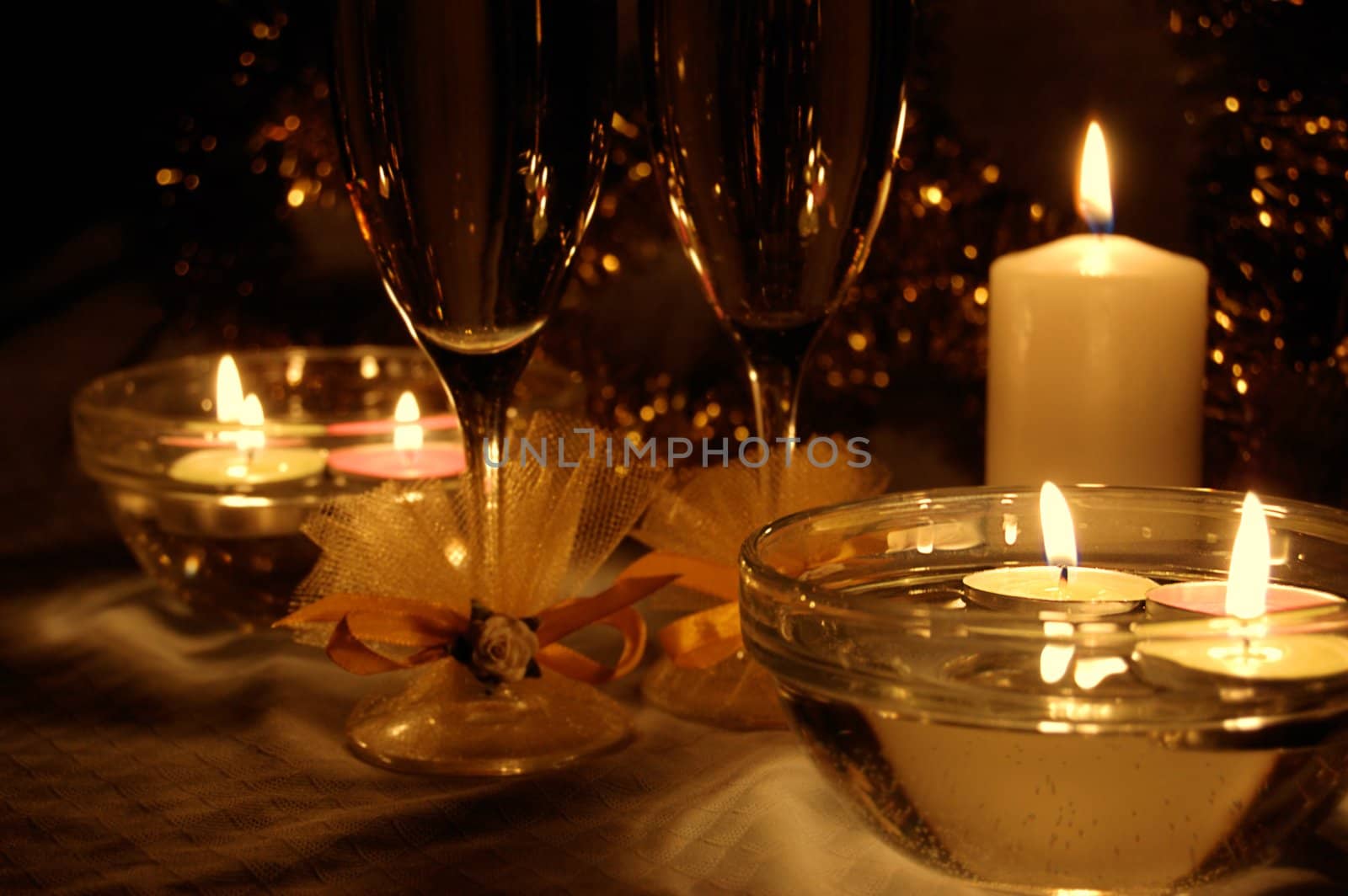 glasses of champagne, candles with christmas decorations