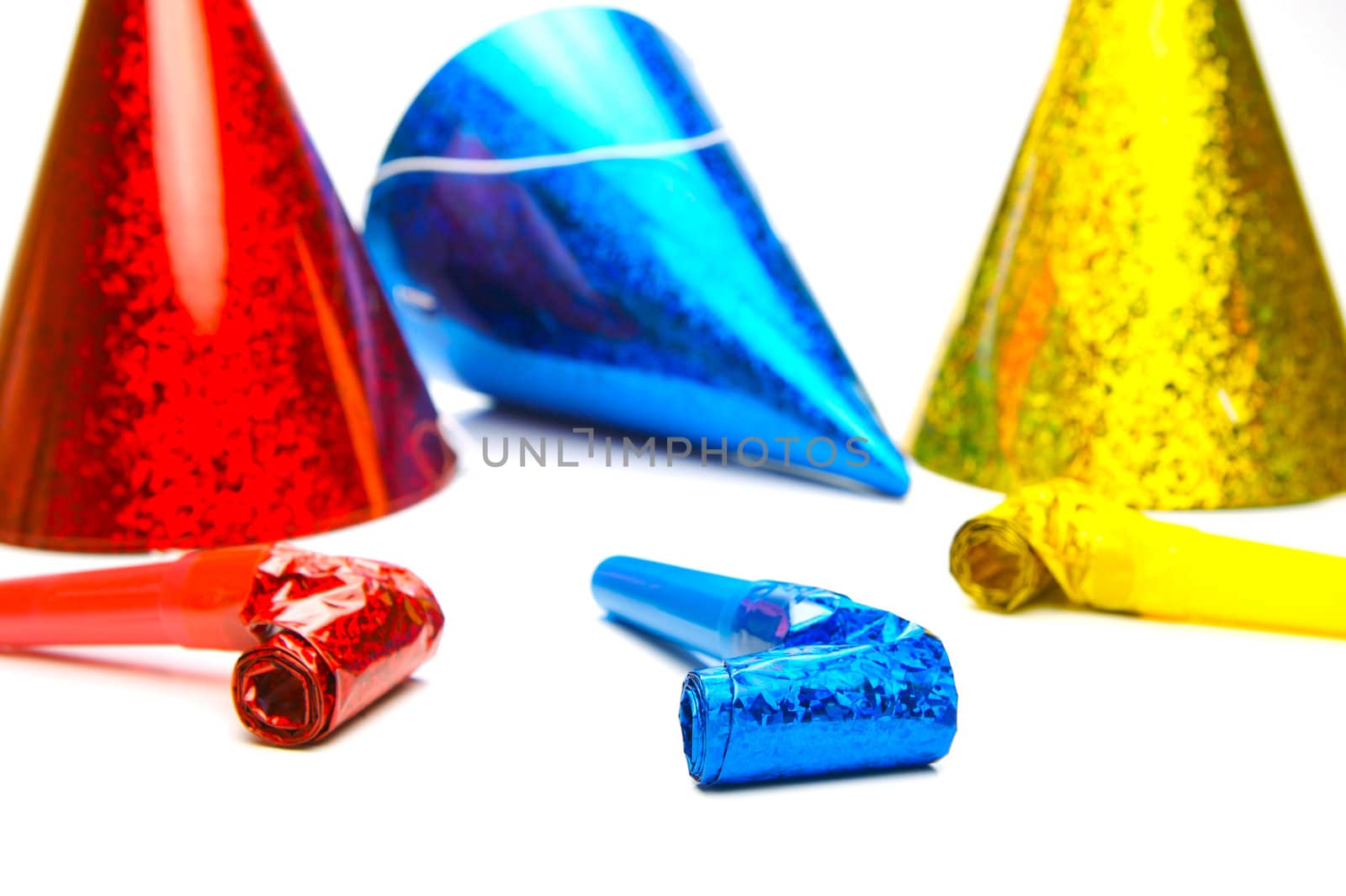 Party hats and blowers isolated against a white background