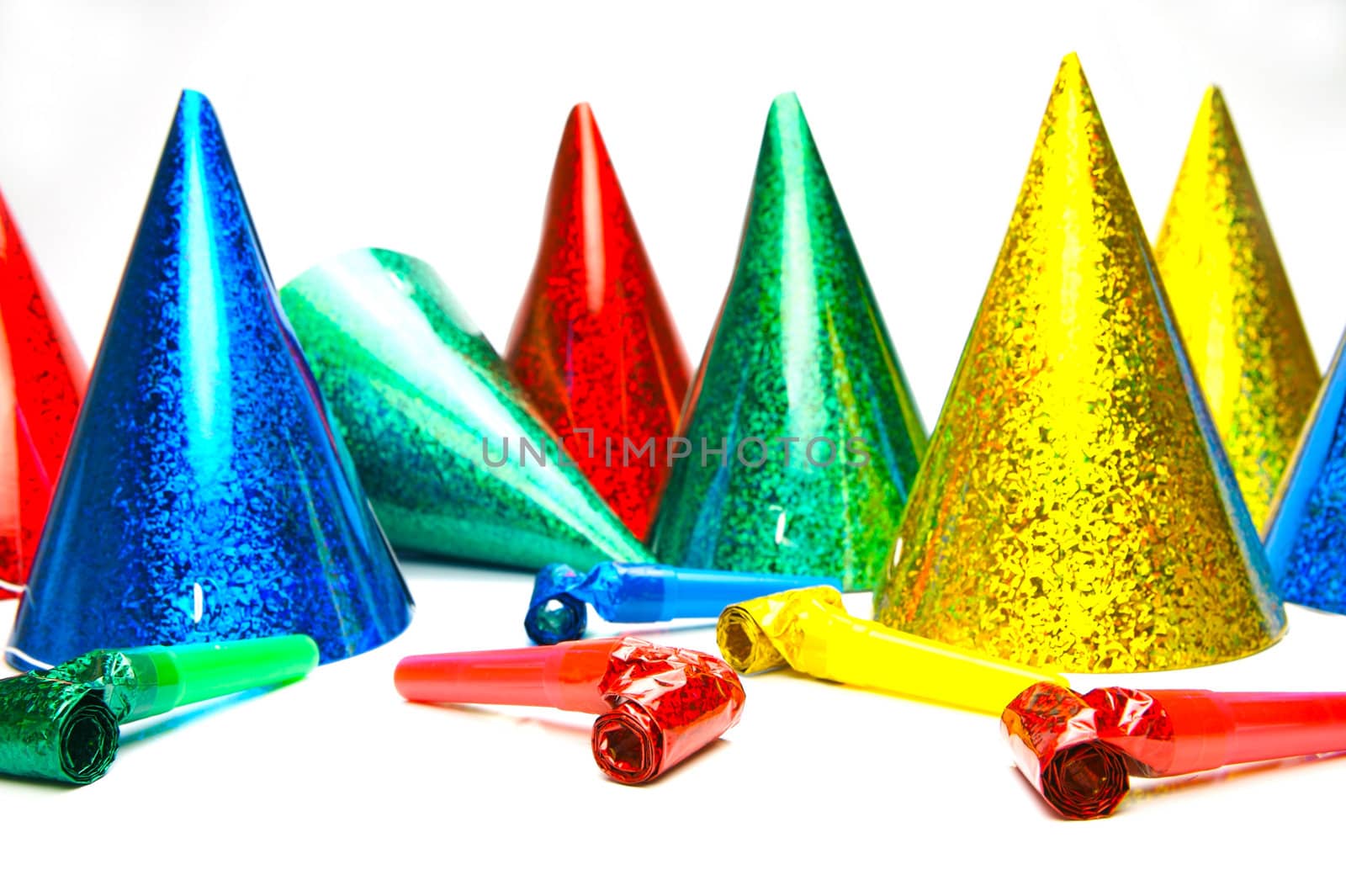Party hats and blowers isolated against a white background