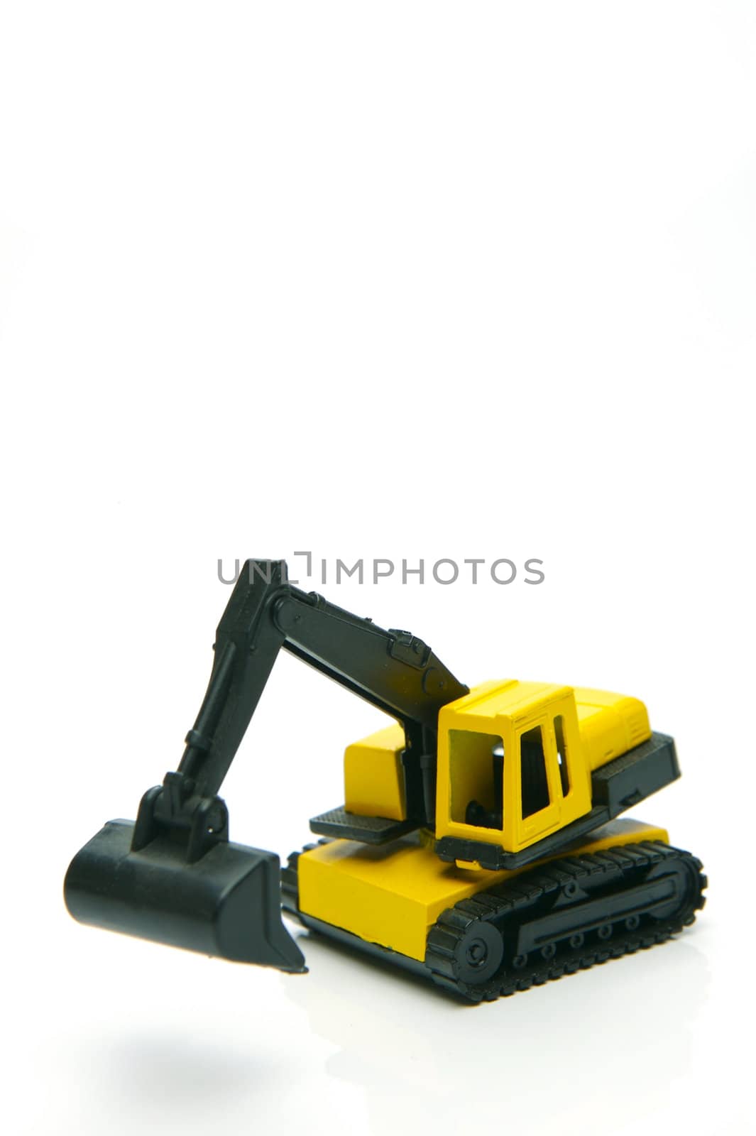 Miniature model earth moving equipment isolated against a white background