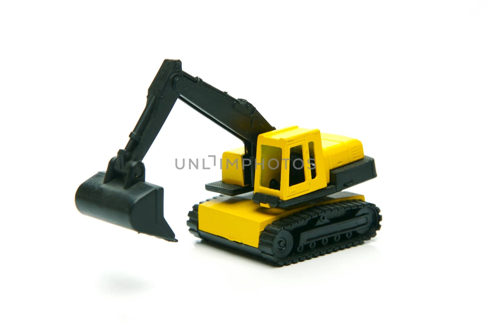 Miniature model earth moving equipment isolated against a white background