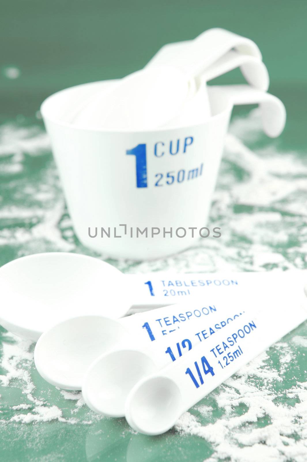 Measuring cups isolated against a green backgroundd