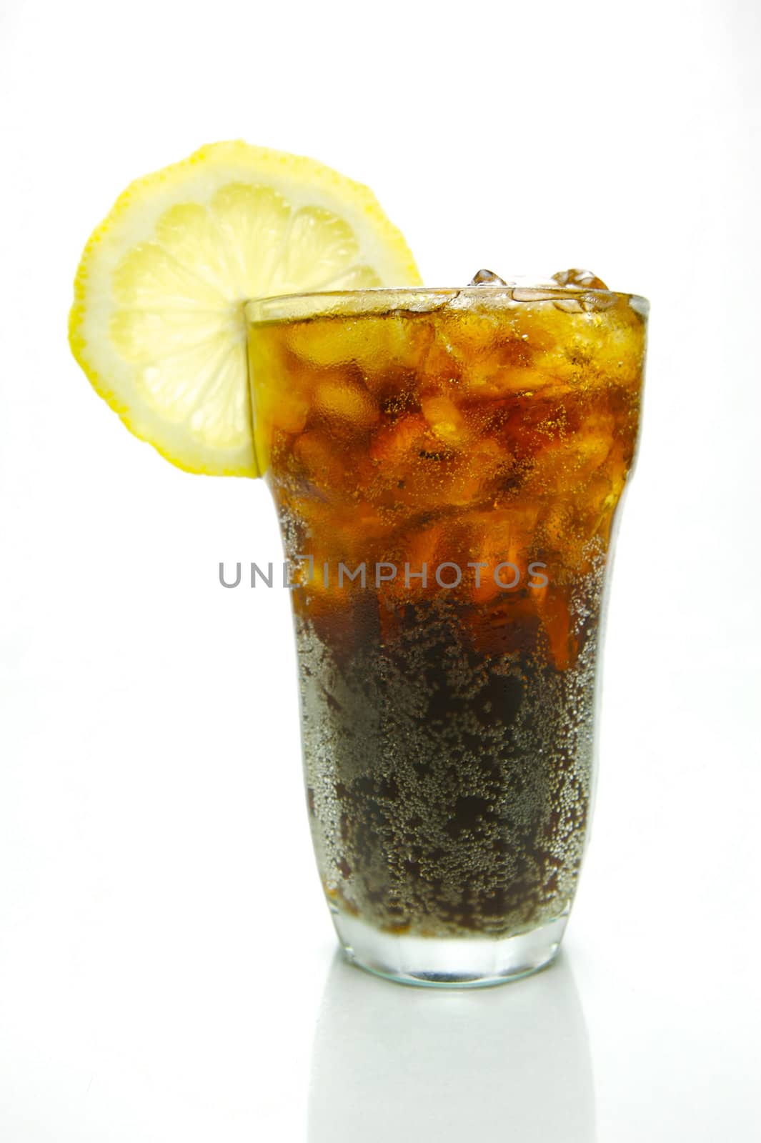 A glass of lemon cola isolated against a white background