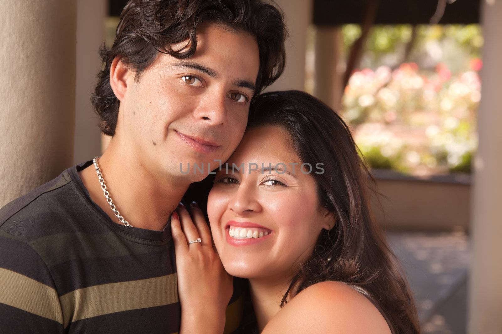 Attractive Hispanic Couple Portrait Enjoying Each Other Outdoors.