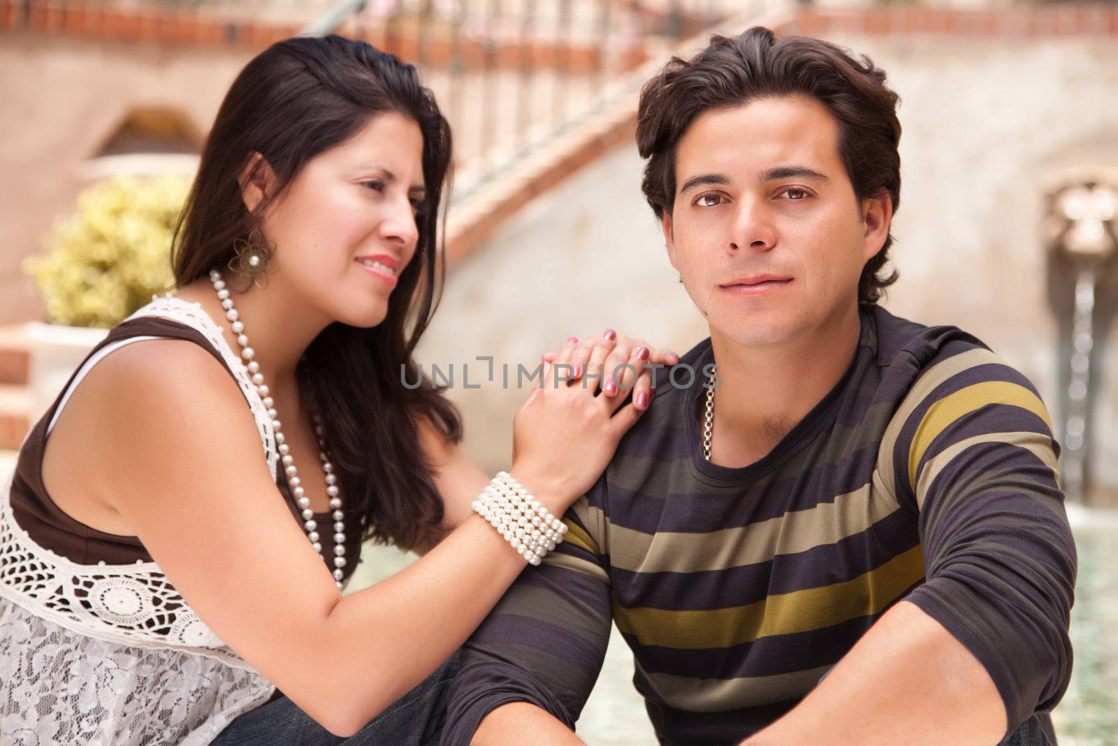 Attractive Hispanic Couple Portrait Enjoying Each Other Outdoors.