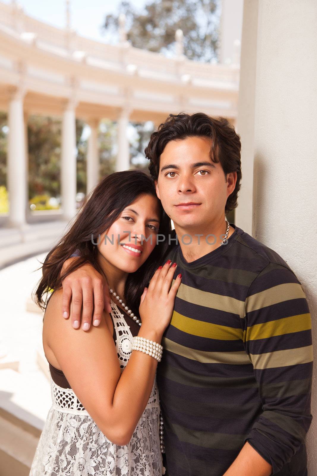 Attractive Hispanic Couple Portrait Enjoying Each Other Outdoors.