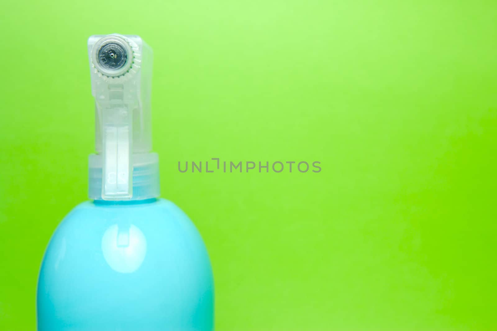 A spray bottle isolated against a blue background