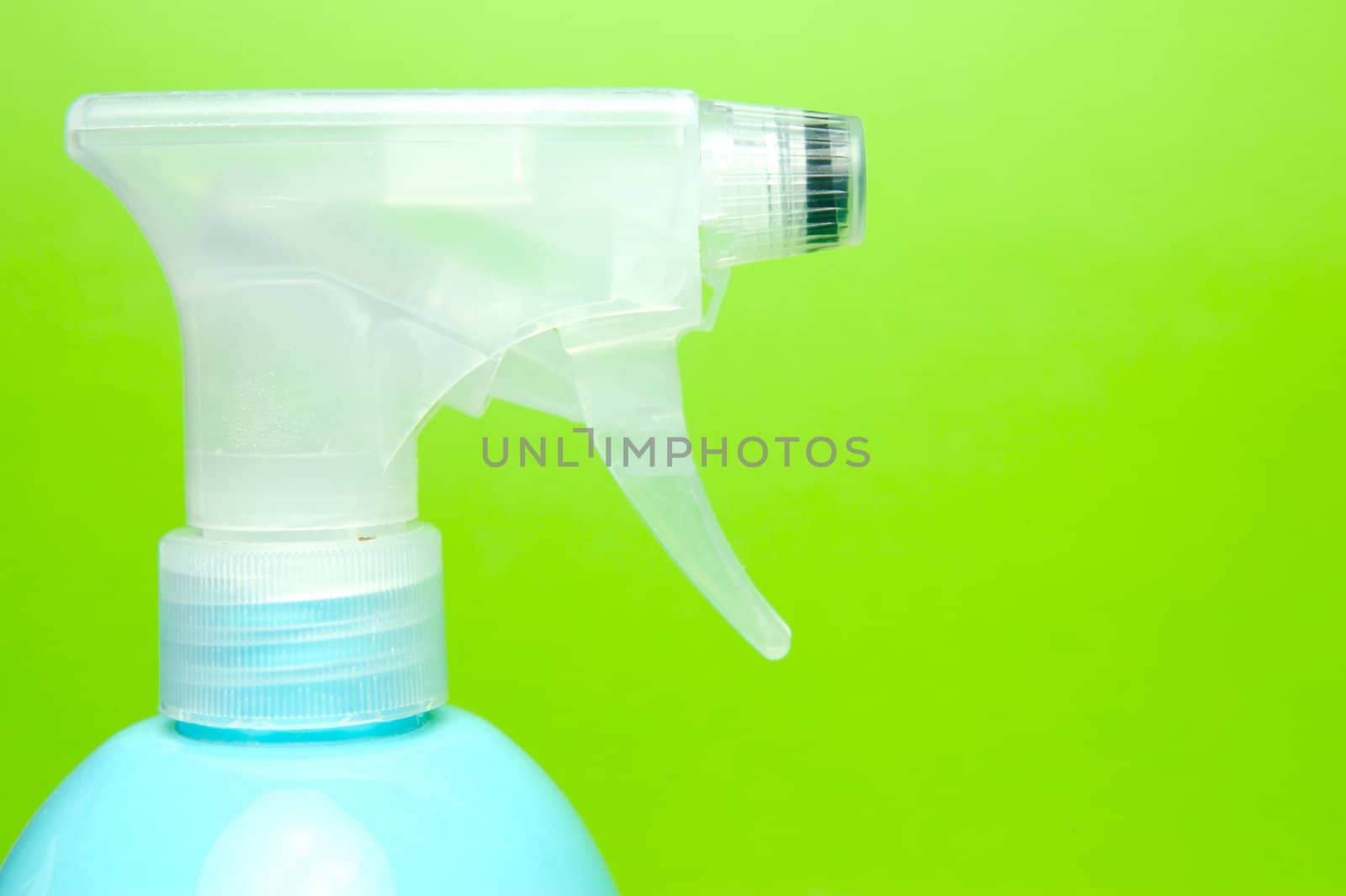 A spray bottle isolated against a blue background