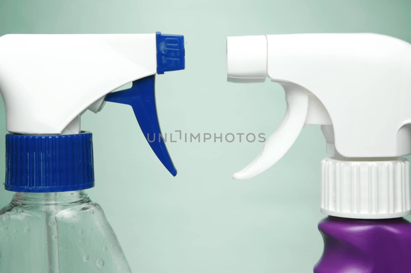 Cleaning products isolated against a green background