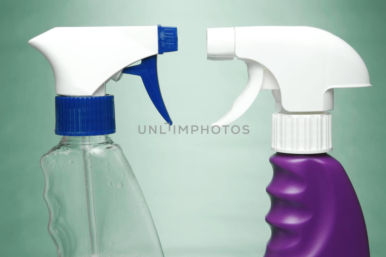 Cleaning products isolated against a green background