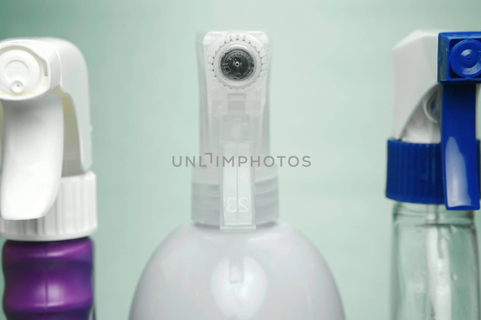 Cleaning products isolated against a green background