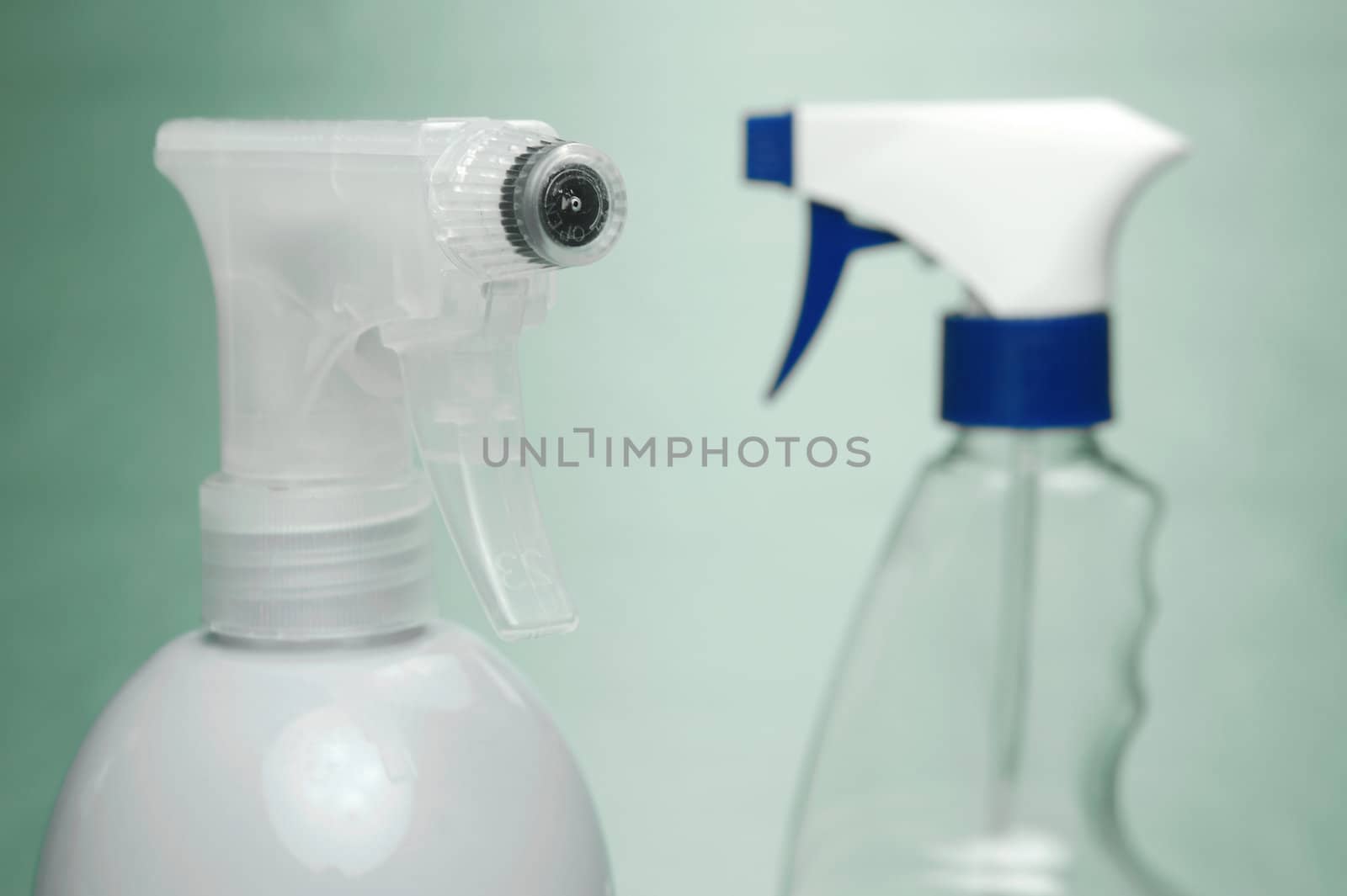 Cleaning products isolated against a green background