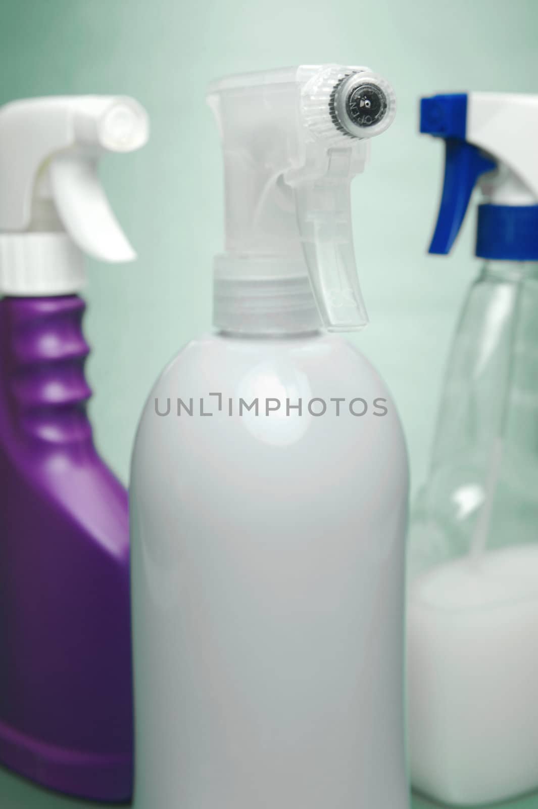 Cleaning products isolated against a green background