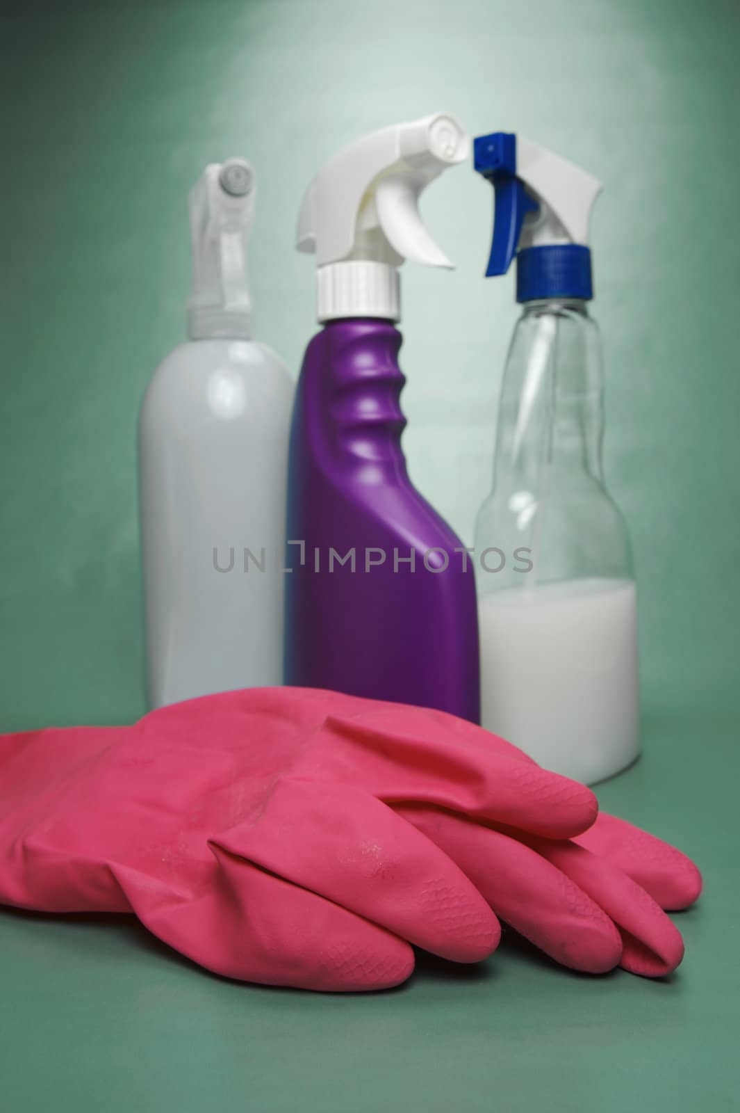 Cleaning products isolated against a green background