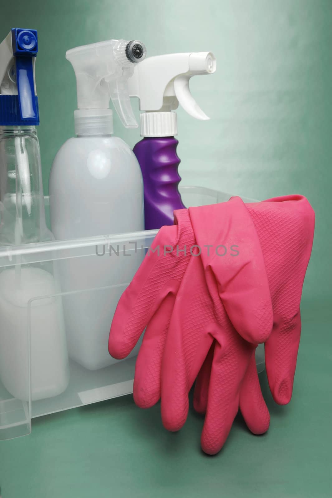 Cleaning products isolated against a green background