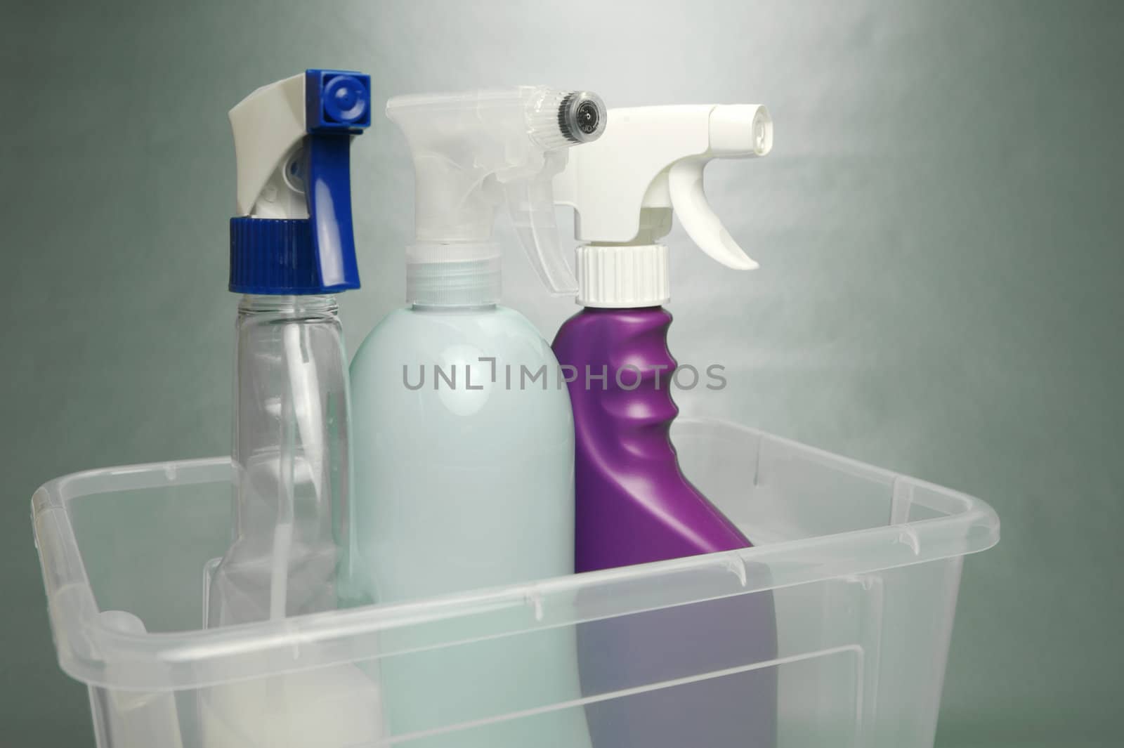 Cleaning products isolated against a green background