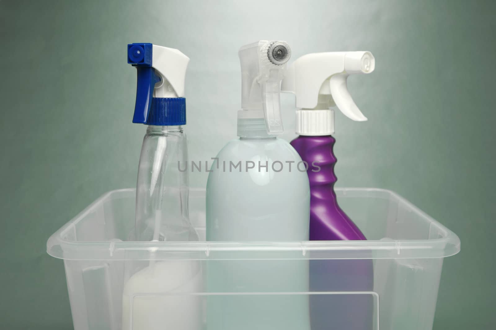 Cleaning products isolated against a green background