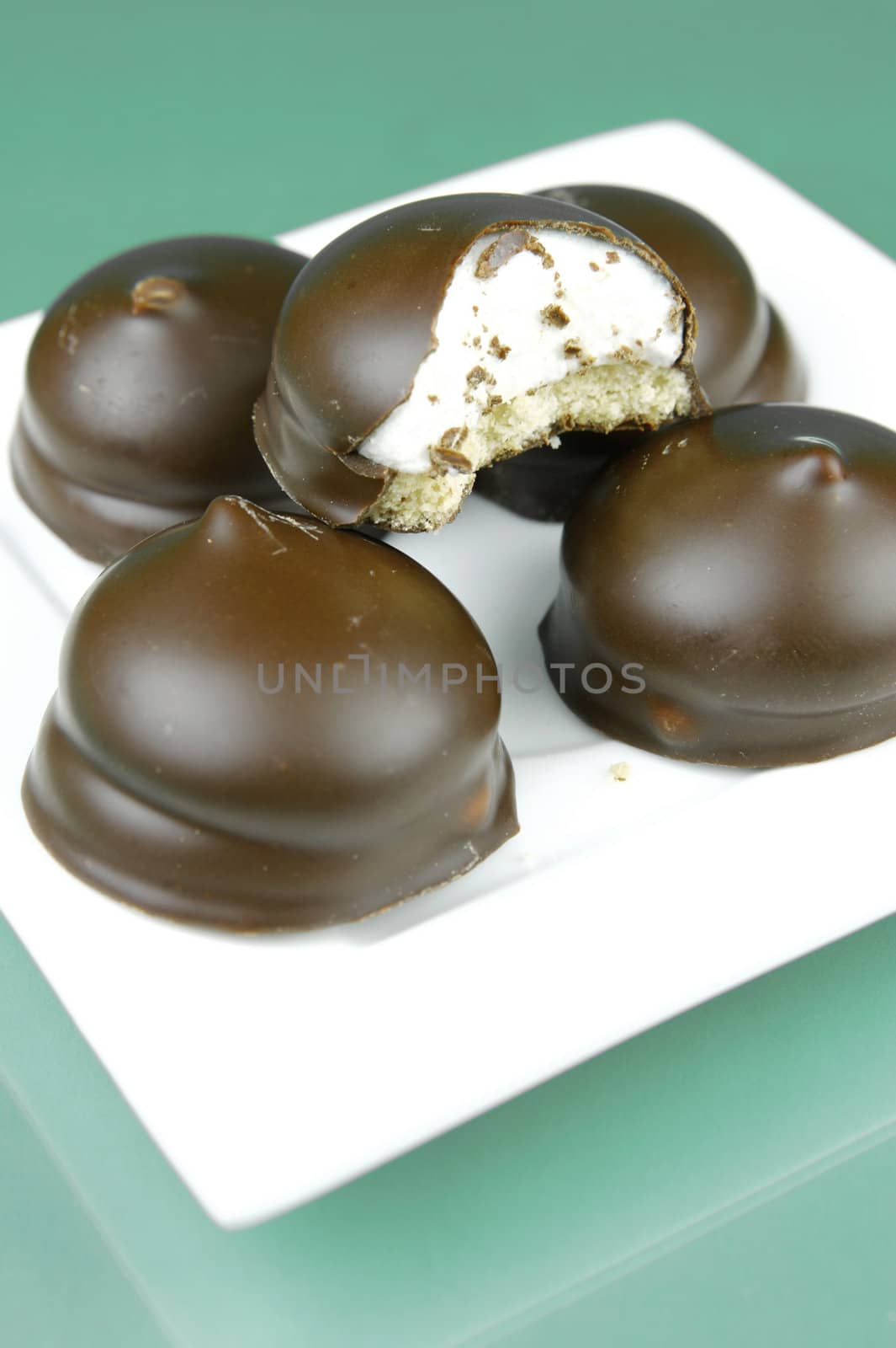 Marshmallow biscuits isolated against a green background